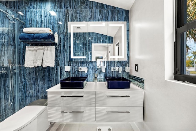6166 Pine Tree Dr, Miami Beach, FL 33140 - bathroom featuring lofted ceiling, vanity, and tasteful backsplash