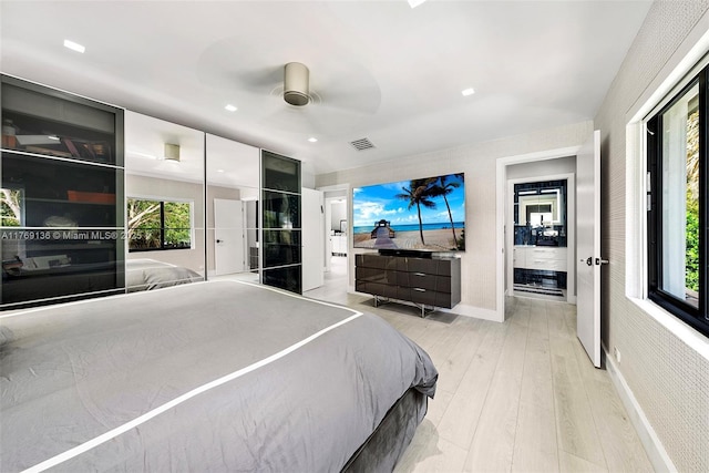 bedroom featuring light wood-style flooring, ceiling fan, and baseboards