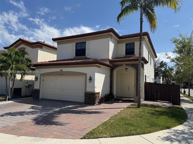 10086 NW 89th Ter, Doral, FL 33178 - mediterranean / spanish home featuring stone siding, a tile roof, decorative driveway, and stucco siding