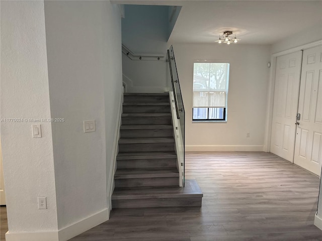 10086 NW 89th Ter, Doral, FL 33178 - stairs with baseboards, wood finished floors, and an inviting chandelier