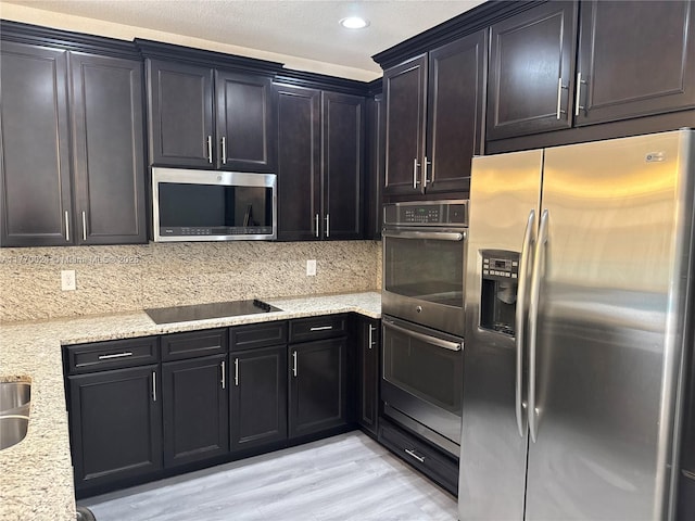10086 NW 89th Ter, Doral, FL 33178 - kitchen with light stone countertops, light wood-style floors, decorative backsplash, and appliances with stainless steel finishes