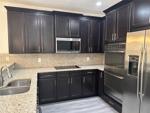 10086 NW 89th Ter, Doral, FL 33178 - kitchen featuring decorative backsplash, light stone countertops, appliances with stainless steel finishes, a sink, and light wood-style floors