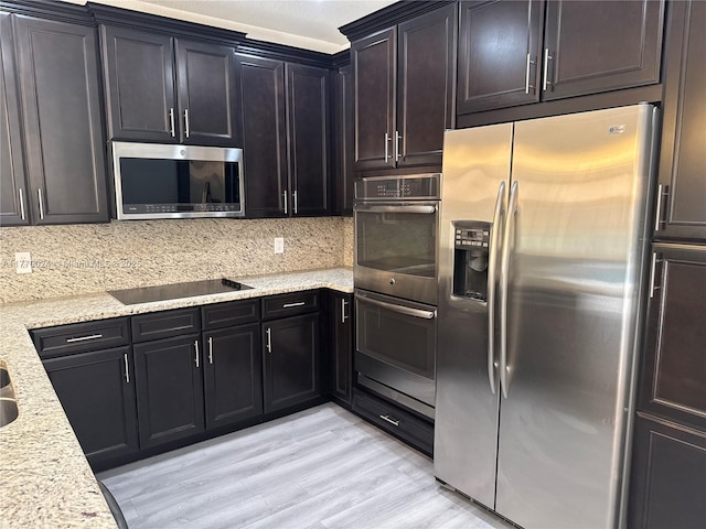 10086 NW 89th Ter, Doral, FL 33178 - kitchen with backsplash, light wood-style flooring, stainless steel appliances, and light stone counters