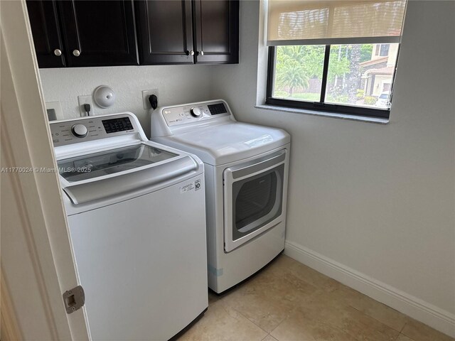 10086 NW 89th Ter, Doral, FL 33178 - laundry room featuring baseboards, cabinet space, and washer and dryer