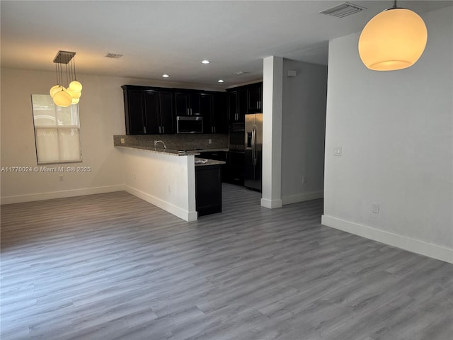 10086 NW 89th Ter, Doral, FL 33178 - kitchen with dark cabinetry, appliances with stainless steel finishes, a peninsula, open floor plan, and visible vents