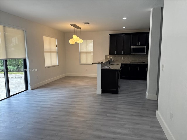 10086 NW 89th Ter, Doral, FL 33178 - kitchen featuring tasteful backsplash, stainless steel microwave, dark cabinetry, baseboards, and visible vents