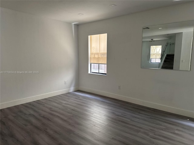 10086 NW 89th Ter, Doral, FL 33178 - unfurnished room featuring baseboards, dark wood-style floors, and stairway