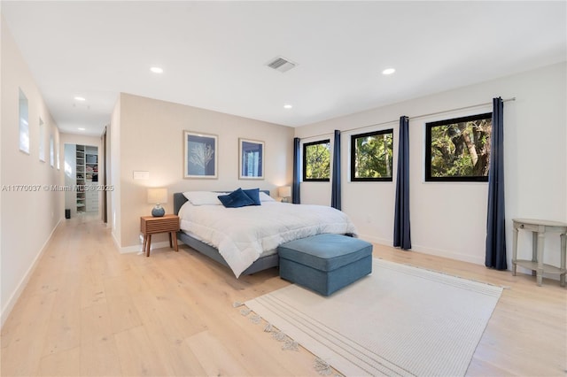 bedroom featuring recessed lighting, baseboards, light wood finished floors, and visible vents