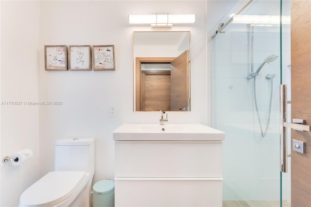 full bathroom with vanity, toilet, and tiled shower