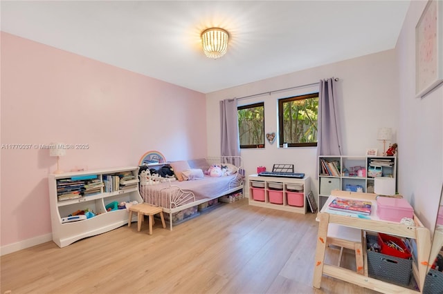 bedroom featuring baseboards and wood finished floors