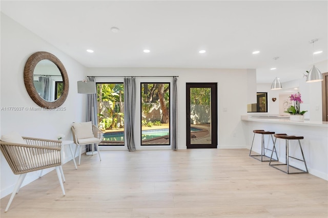interior space featuring baseboards, recessed lighting, and light wood-style floors