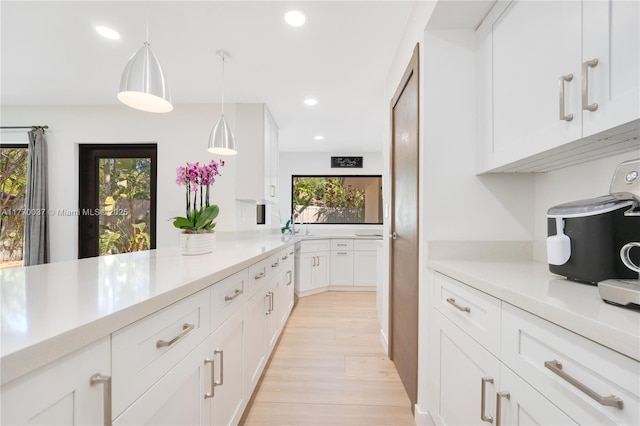 kitchen featuring white cabinetry, light countertops, and plenty of natural light