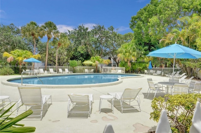 2761 S Oakland Forest Dr Unit 201, Oakland Park, FL 33309 - community pool with fence and a patio area