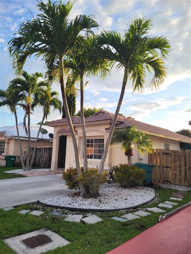 14144 SW 149th Pl, Miami, FL 33196 - view of front of house featuring driveway, stucco siding, fence, and a tile roof