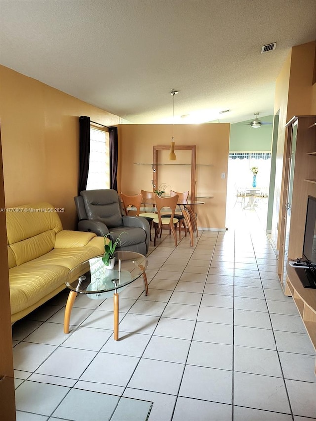 14144 SW 149th Pl, Miami, FL 33196 - living area with a textured ceiling, light tile patterned flooring, vaulted ceiling, and visible vents