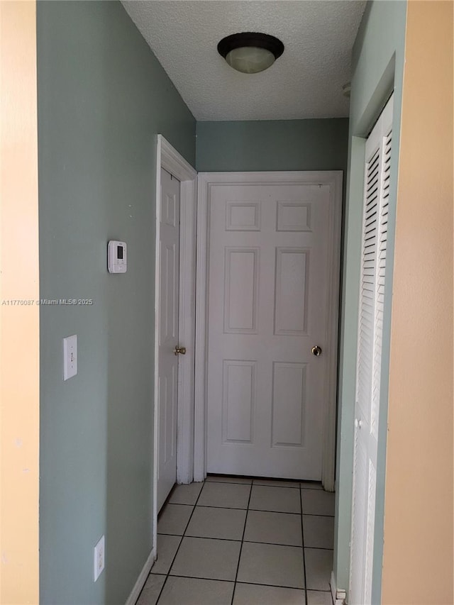 14144 SW 149th Pl, Miami, FL 33196 - corridor with a textured ceiling and light tile patterned floors