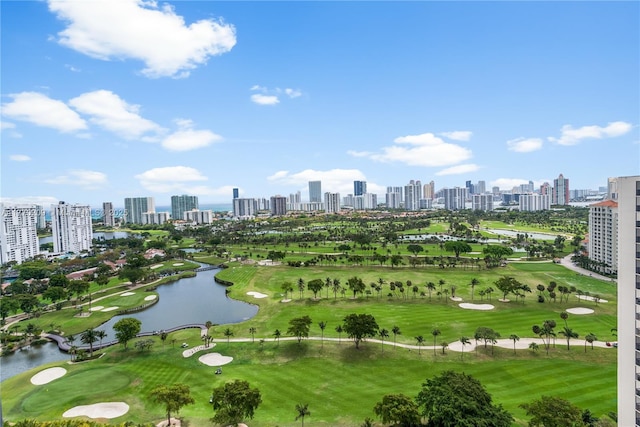 birds eye view of property with golf course view, a water view, and a city view