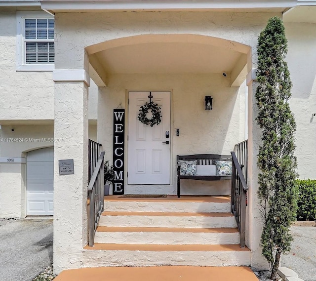 doorway to property featuring stucco siding