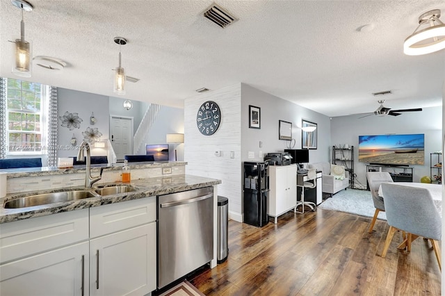 kitchen with open floor plan, stainless steel dishwasher, a sink, ceiling fan, and visible vents