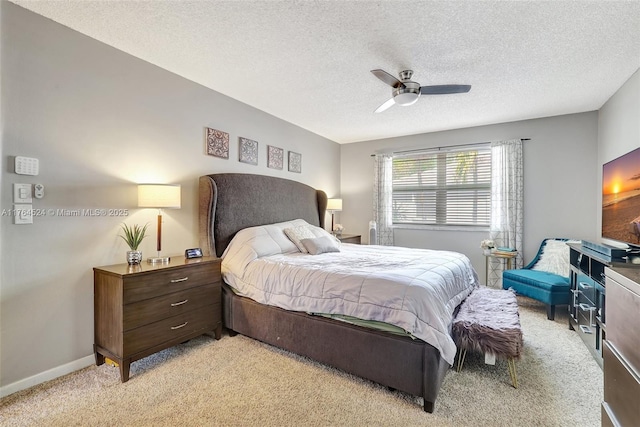 bedroom with a textured ceiling, ceiling fan, baseboards, and light colored carpet