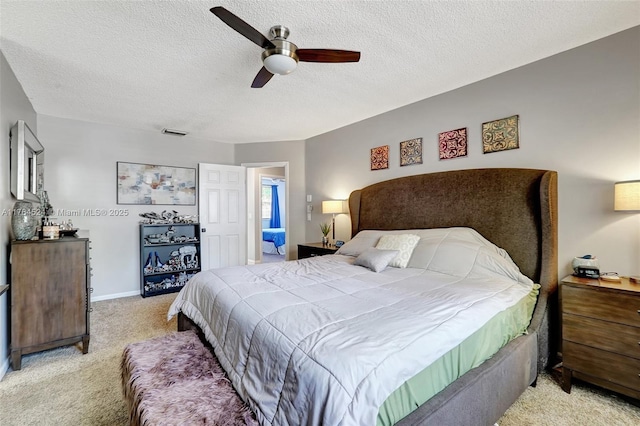 bedroom featuring a ceiling fan, a textured ceiling, baseboards, light colored carpet, and visible vents