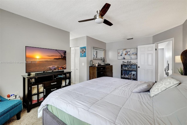 bedroom featuring a closet, a textured ceiling, visible vents, and light carpet