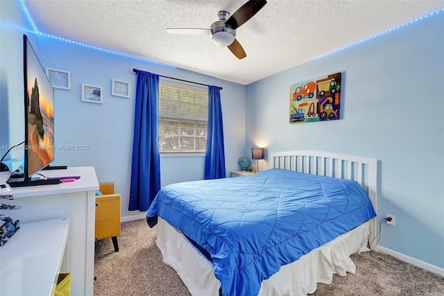 carpeted bedroom featuring baseboards, a textured ceiling, and a ceiling fan