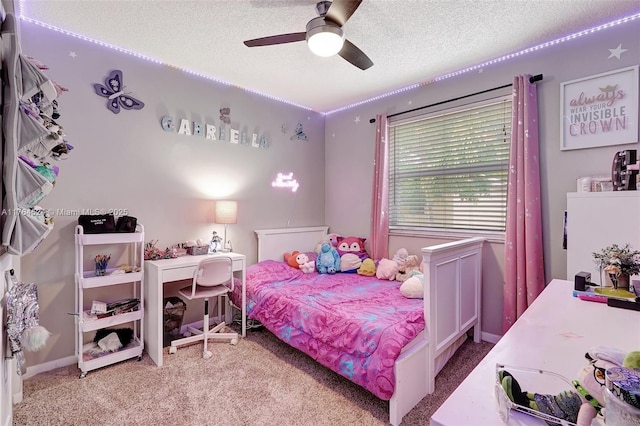 carpeted bedroom with a textured ceiling and a ceiling fan