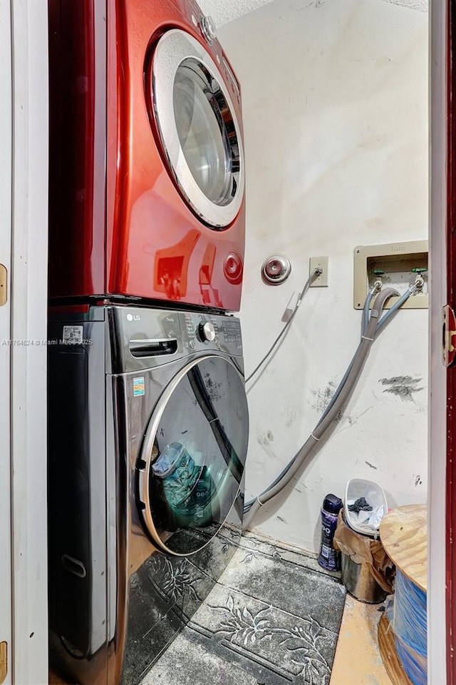 laundry room with stacked washer / dryer and laundry area