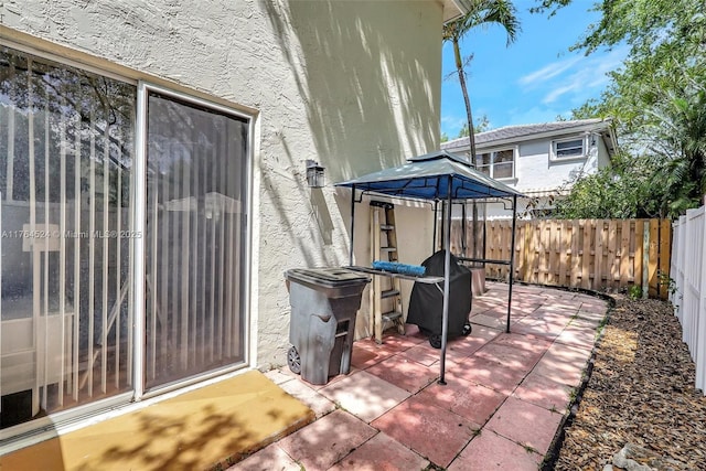 view of patio with a gazebo and fence