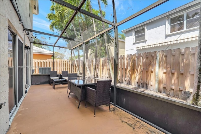 sunroom featuring an outdoor hangout area