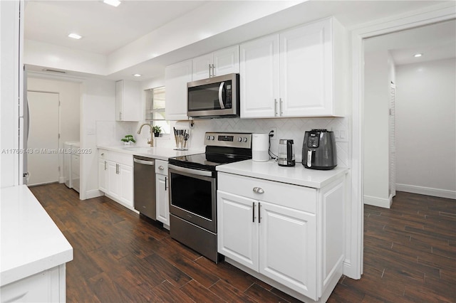 19915 NE 10th Place Way, Miami, FL 33179 - kitchen featuring stainless steel appliances, dark wood-style floors, a sink, tasteful backsplash, and recessed lighting