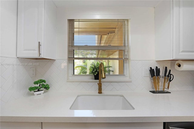 19915 NE 10th Place Way, Miami, FL 33179 - kitchen with a sink, white cabinetry, and tasteful backsplash