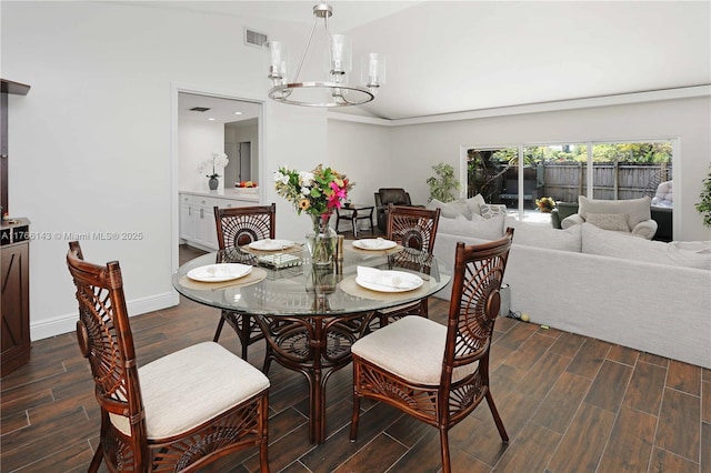 19915 NE 10th Place Way, Miami, FL 33179 - dining room with a chandelier, wood finished floors, vaulted ceiling, and baseboards
