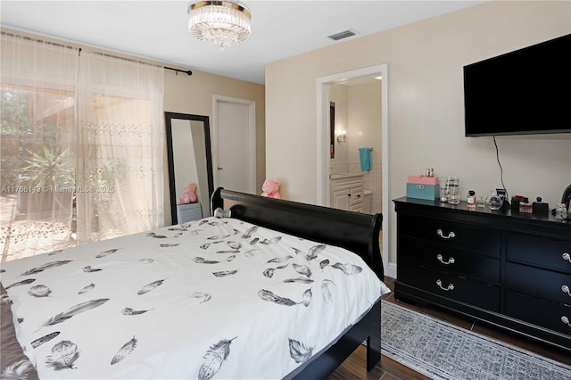 19915 NE 10th Place Way, Miami, FL 33179 - bedroom featuring dark wood-type flooring, connected bathroom, and a chandelier