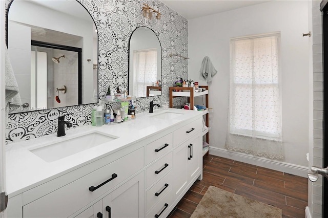 19915 NE 10th Place Way, Miami, FL 33179 - full bath featuring baseboards, a shower stall, wood finished floors, double vanity, and wallpapered walls