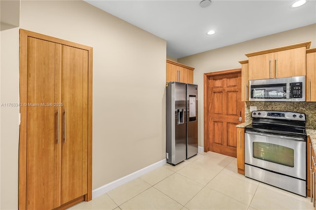 kitchen featuring backsplash, appliances with stainless steel finishes, light tile patterned floors, baseboards, and recessed lighting