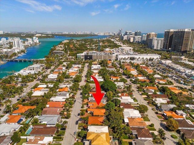 birds eye view of property with a water view and a city view