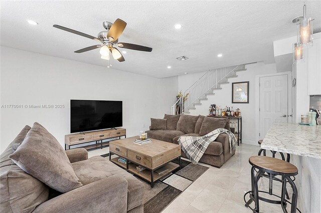 8 Hathaway Ln, Wilton Manors, FL 33305 - living room with stairway, a ceiling fan, recessed lighting, light marble finish flooring, and a textured ceiling