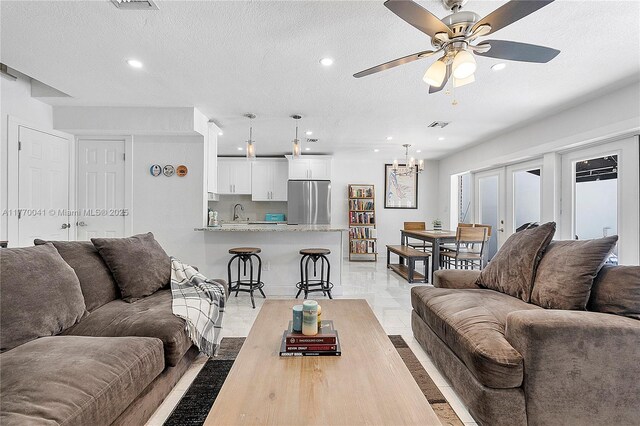 8 Hathaway Ln, Wilton Manors, FL 33305 - living area featuring ceiling fan, a chandelier, recessed lighting, a textured ceiling, and french doors