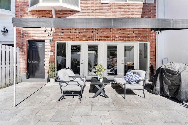 view of patio featuring french doors and fence