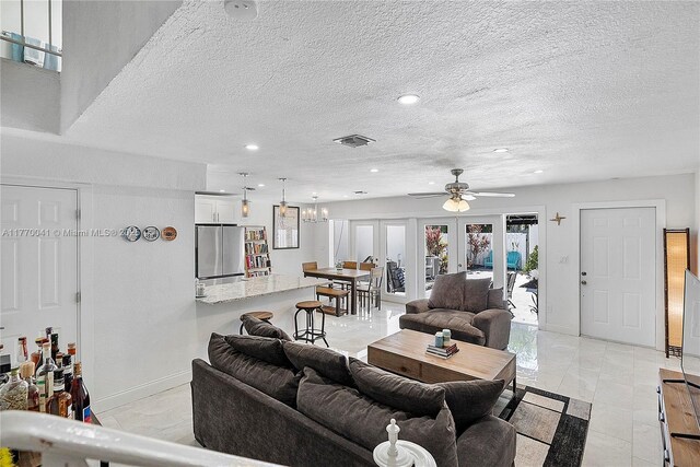 8 Hathaway Ln, Wilton Manors, FL 33305 - living area featuring french doors, a ceiling fan, recessed lighting, baseboards, and a textured ceiling