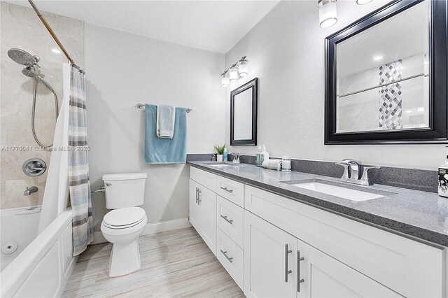 8 Hathaway Ln, Wilton Manors, FL 33305 - bathroom featuring double vanity, toilet, shower / bath combination with curtain, wood finished floors, and baseboards