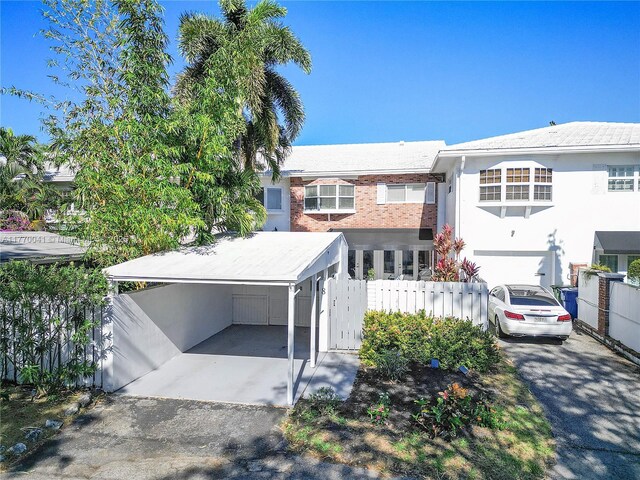 8 Hathaway Ln, Wilton Manors, FL 33305 - view of front facade with driveway, a garage, and brick siding