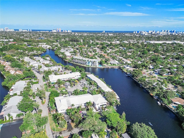 birds eye view of property featuring a water view, a residential view, and a city view