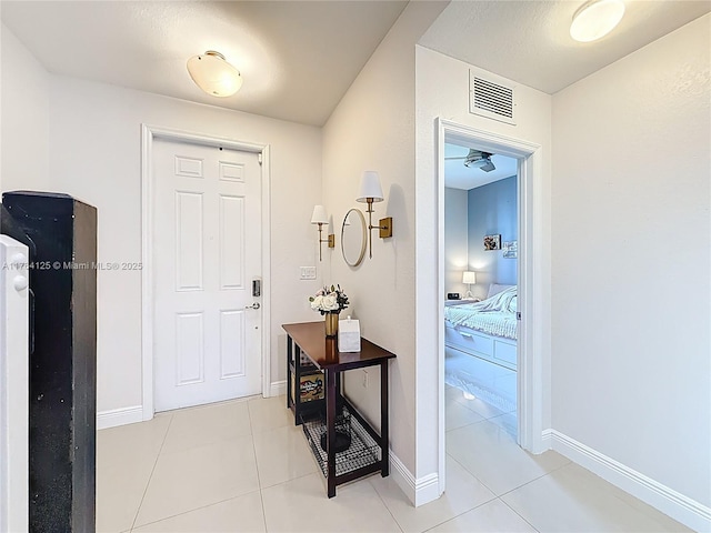 entrance foyer featuring visible vents, baseboards, and light tile patterned floors