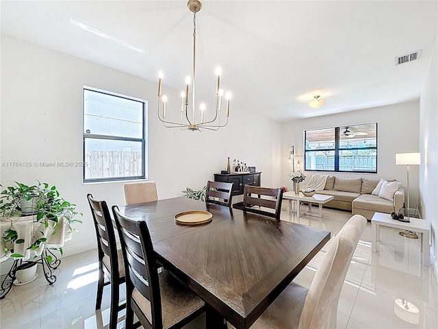 dining room featuring visible vents, baseboards, an inviting chandelier, and light tile patterned flooring