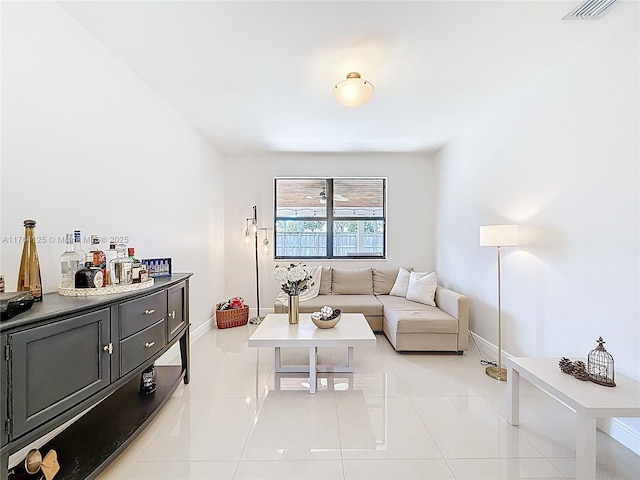 living room with visible vents, baseboards, and light tile patterned flooring