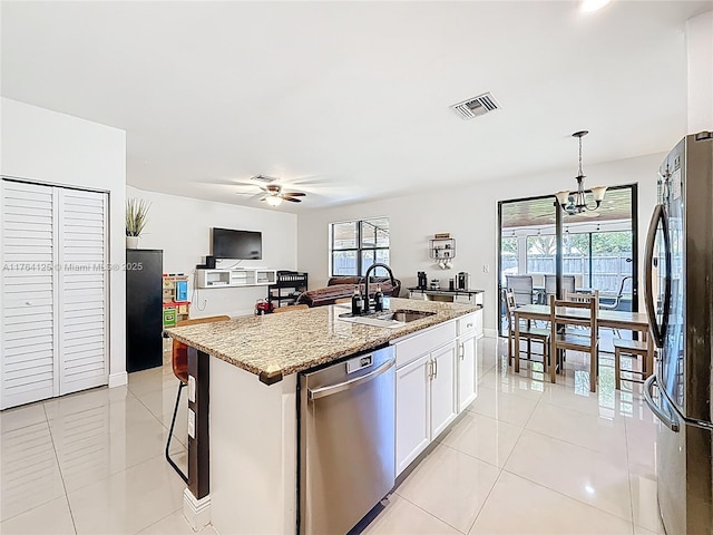 kitchen featuring visible vents, light tile patterned floors, a sink, light stone countertops, and stainless steel appliances
