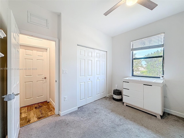 bedroom featuring a closet, baseboards, visible vents, ceiling fan, and carpet floors